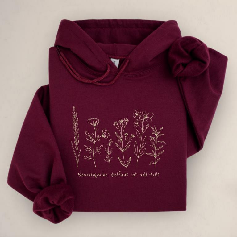 Gemütlicher Unisex aus Baumwolle Hoodie mit floraler Illustration und dem Schriftzug „Neurologische Vielfalt ist voll toll!“ – Statement für neurodivergente Sichtbarkeit.