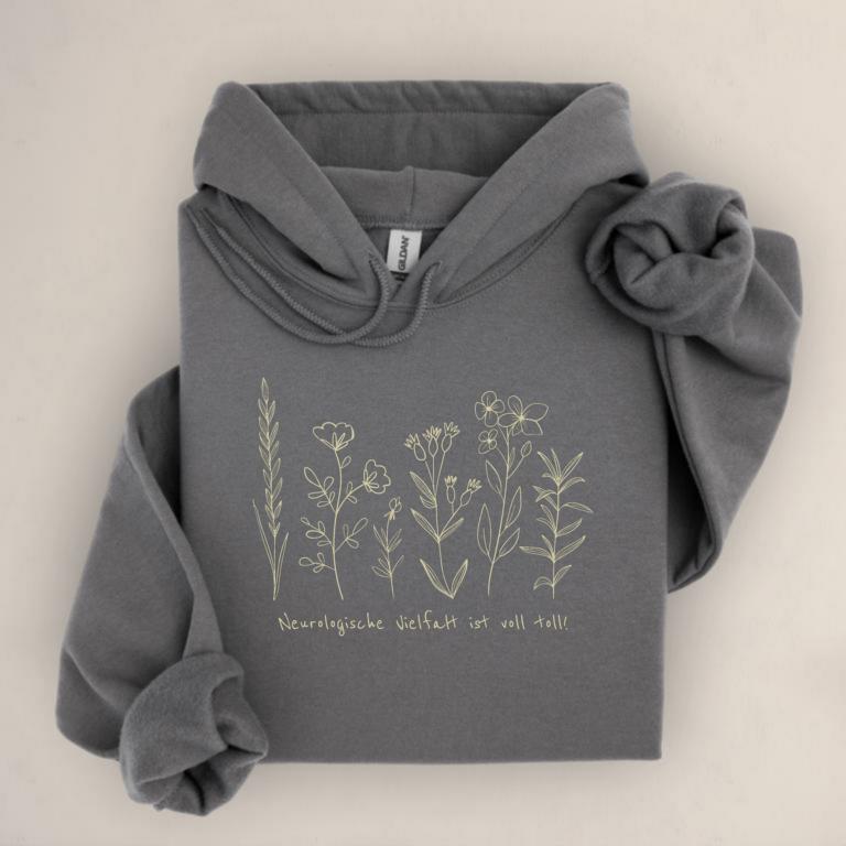 Gemütlicher Unisex aus Baumwolle Hoodie mit floraler Illustration und dem Schriftzug „Neurologische Vielfalt ist voll toll!“ – Statement für neurodivergente Sichtbarkeit.